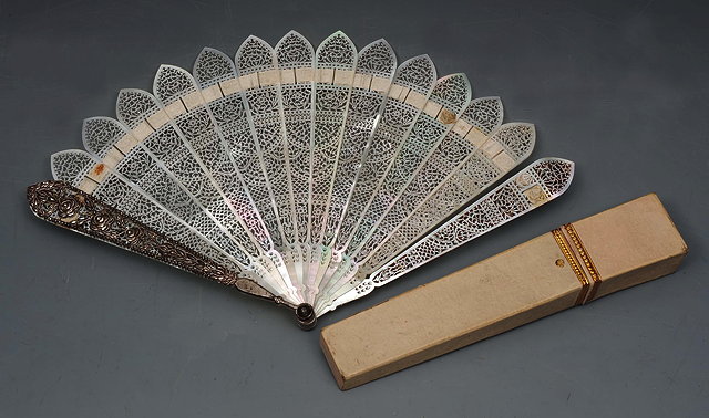 Appraisal: A TH CENTURY MOTHER OF PEARL FAN the sticks intricately