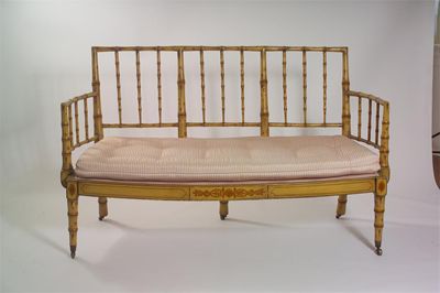 Appraisal: A faux bamboo settee with bow front seat and brass