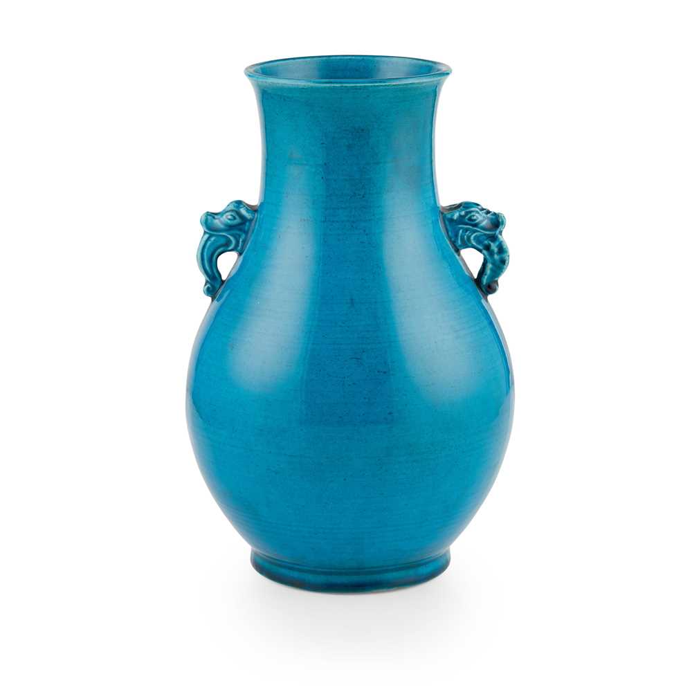 Appraisal: TURQUOISE-GLAZED HANDLED VASE QING DYNASTY TH CENTURY rising from a