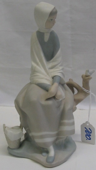 Appraisal: LLADRO BISQUE FIGURE of young woman seated watching a songbird