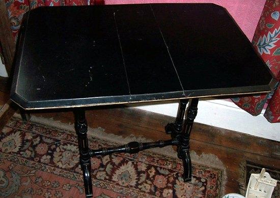 Appraisal: A Victorian ebonised Sutherland table the canted rectangular top on