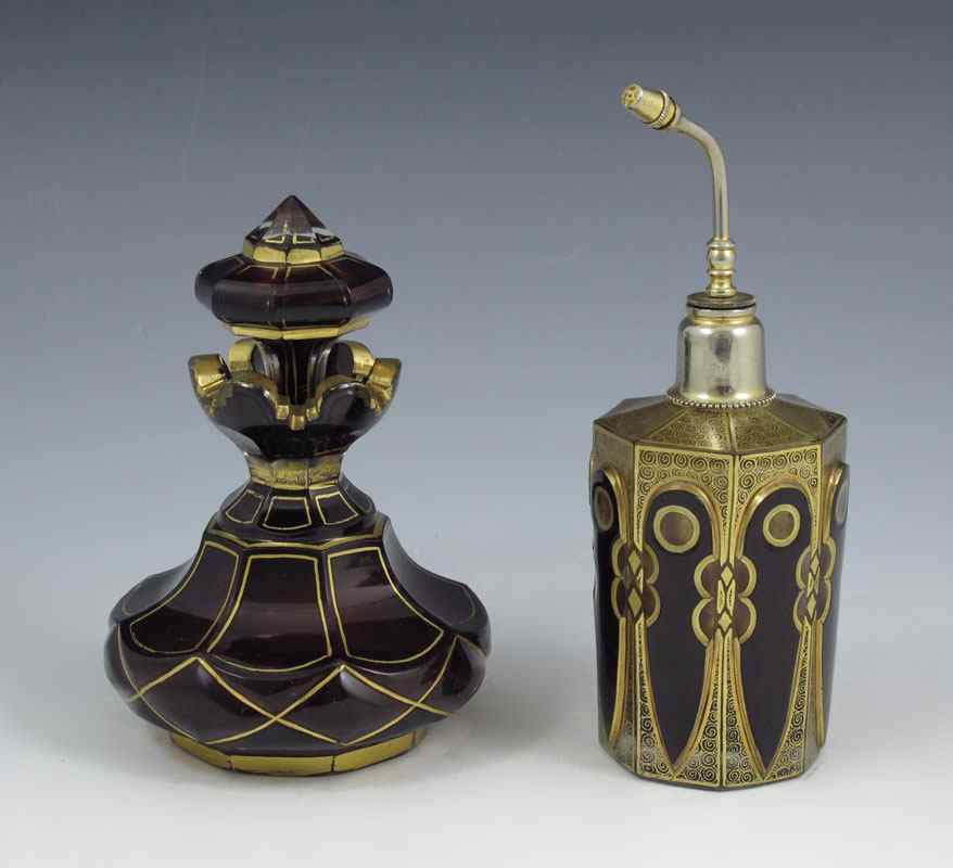 Appraisal: EARLY CZECH GILT RUBY GLASS PERFUME BOTTLES An atomizer and