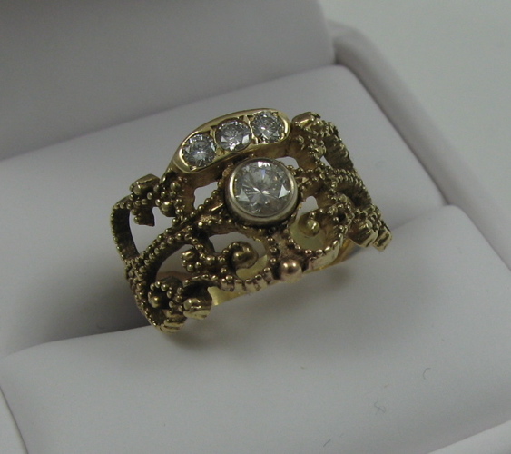 Appraisal: DIAMOND AND FOURTEEN KARAT GOLD RING set with four round-cut