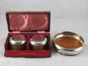 Appraisal: A silver decanter coaster Birmingham together with a boxed pair