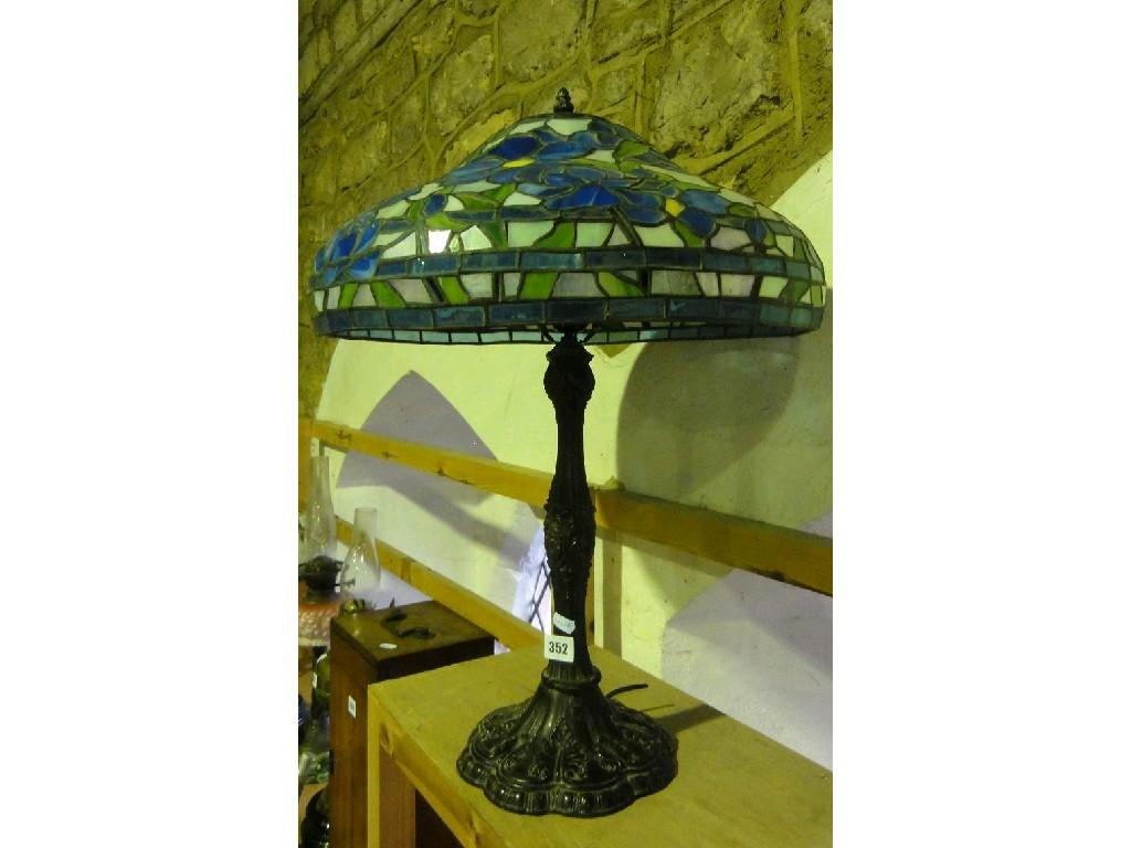 Appraisal: A Tiffany style lamp with a blue floral glass leaded