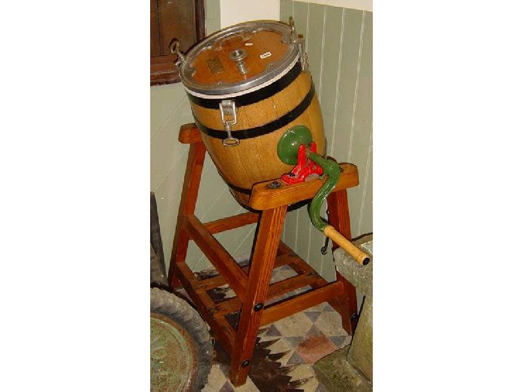 Appraisal: A coopered oak butter churn with iron fittings raised on