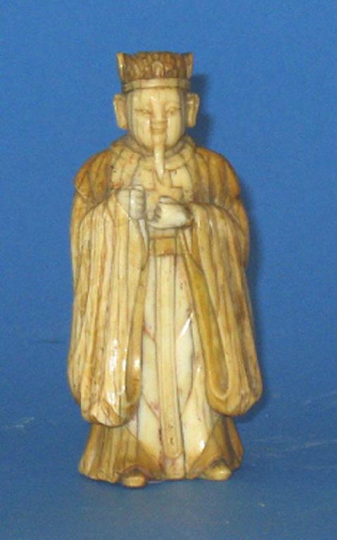 Appraisal: A CHINESE IVORY FIGURE OF A DIGNITARY with a well-patinated