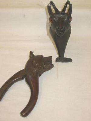 Appraisal: A PAIR OF BLACK FOREST CARVED WOOD NUT CRACKERS modelled