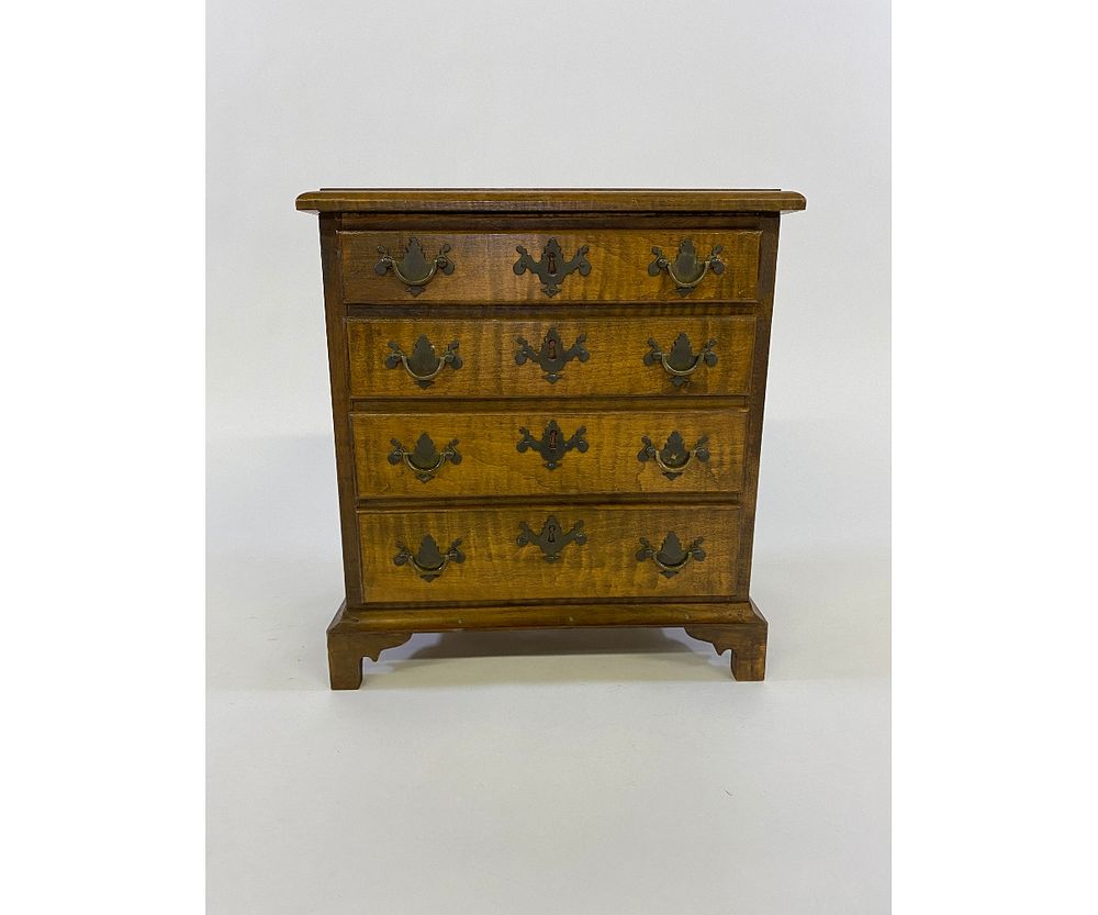 Appraisal: Miniature Chippendale Style Chest of Drawers Miniature Chippendale style tiger