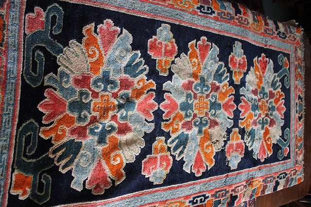 Appraisal: A SINO TIBETAN POLYCHROME RUG cut down and three other