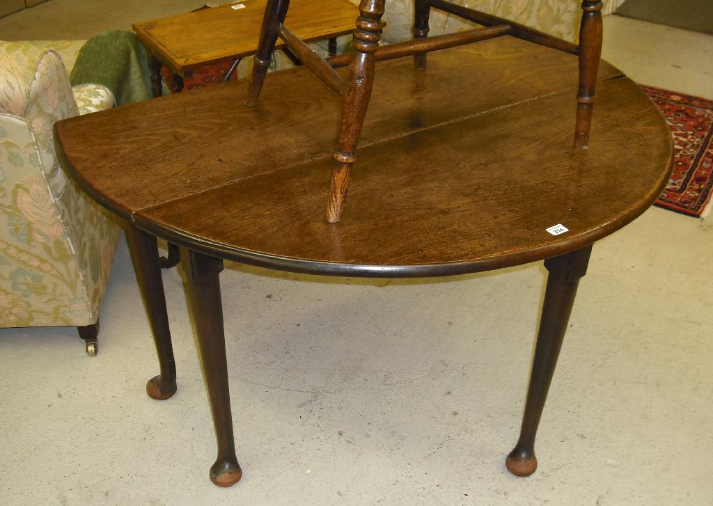 Appraisal: George III oak oval drop flap dining table supported on