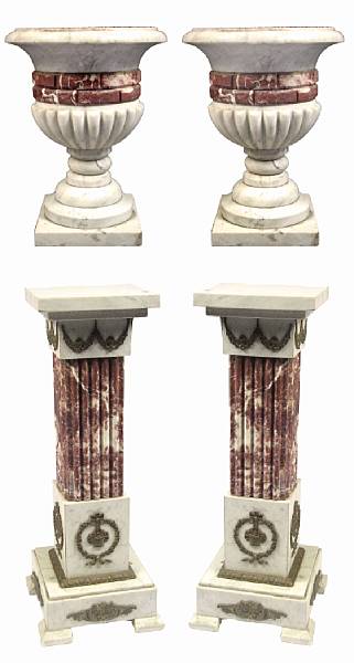 Appraisal: A pair of bicolored marble pedestals and urns height ft