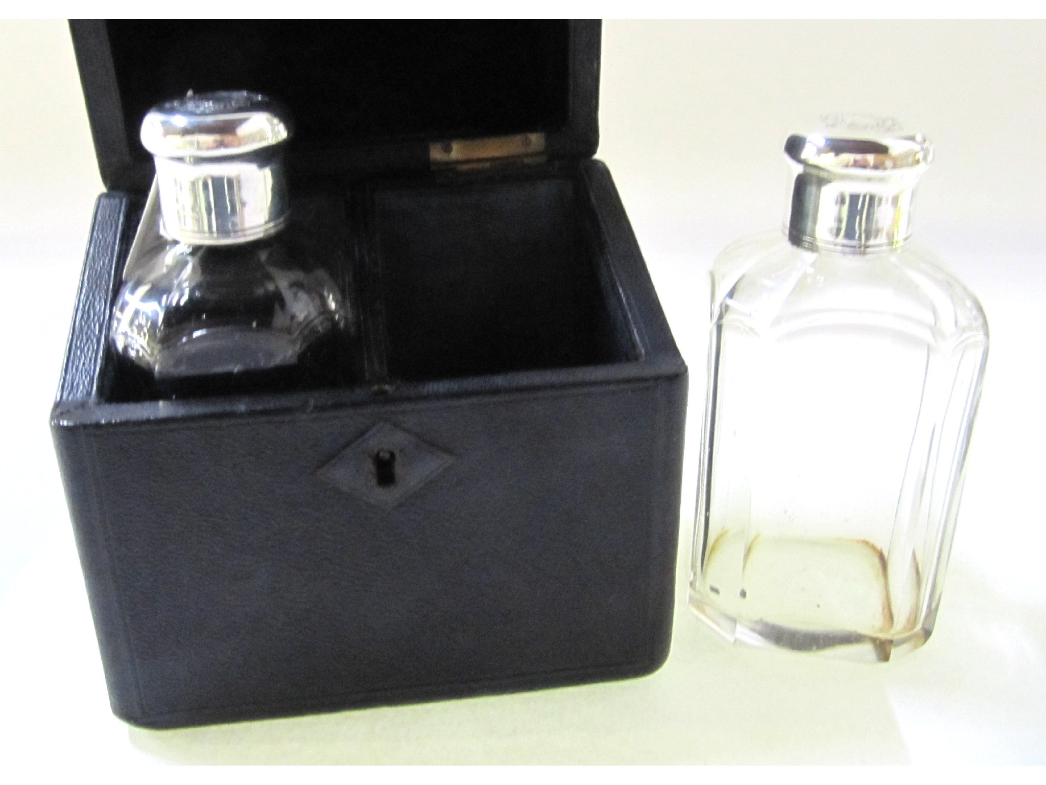 Appraisal: A pair of white metal topped scent bottles in fitted