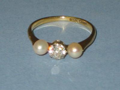 Appraisal: A DIAMOND AND PEARL THREE STONE RING comprising an old