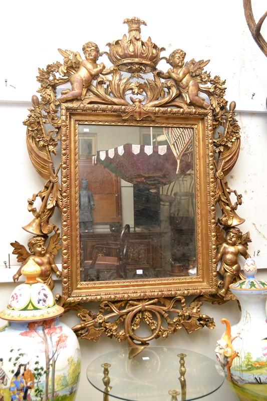 Appraisal: AN IMPRESSIVE HEAVILY CARVED GILT ROCOCO STYLE WALL MIRROR AN