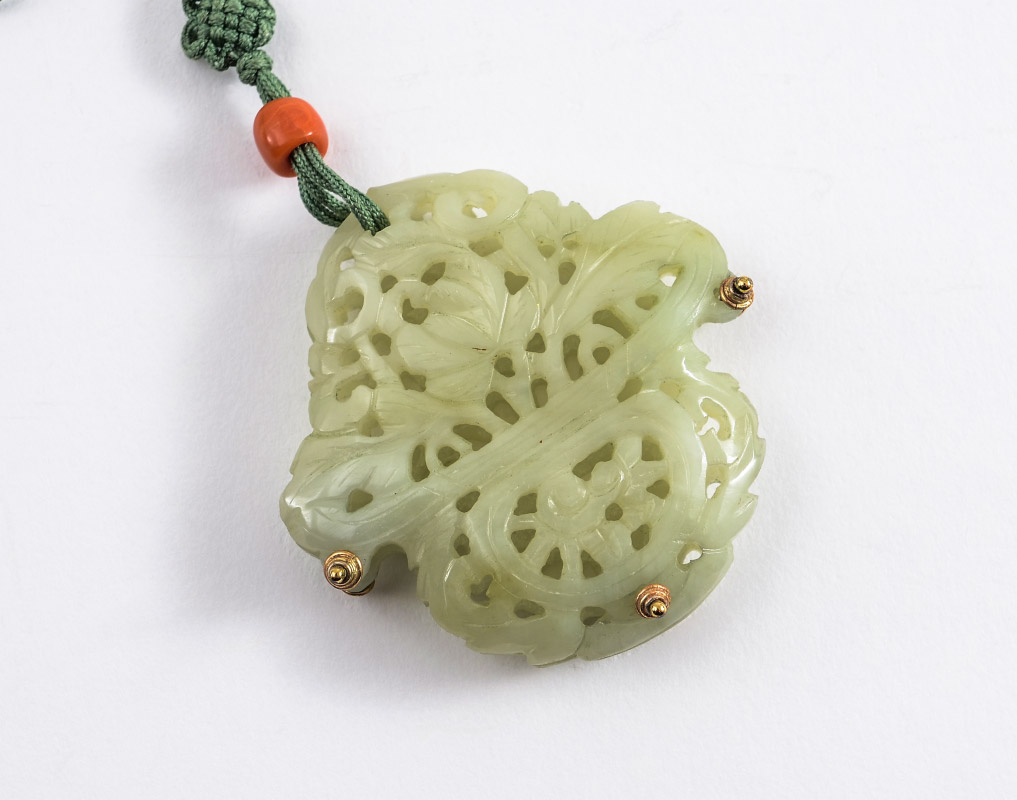 Appraisal: CARVED RETICULATED CHINESE JADE PENDANT Pierced carved hard stone most