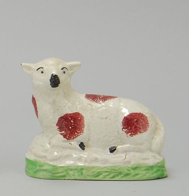 Appraisal: STAFFORDSHIRE CREAMWARE FIGURE OF A RECUMBENT LAMB Circa With rust-red