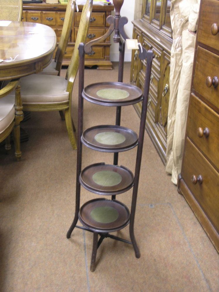 Appraisal: An unusual mahogany folding four tier cake stand each tier