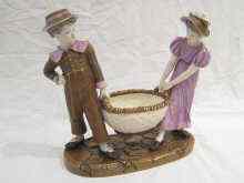 Appraisal: A Royal Worcester group of a boy and girl in