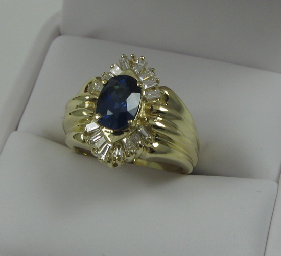 Appraisal: SAPPHIRE DIAMOND AND FOURTEEN KARAT GOLD RING centering an oval-cut