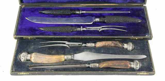 Appraisal: A silver mounted carving set with antler handles cased John