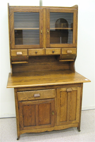 Appraisal: AN OAK 'HOOSIER' KITCHEN CABINET American early th century in