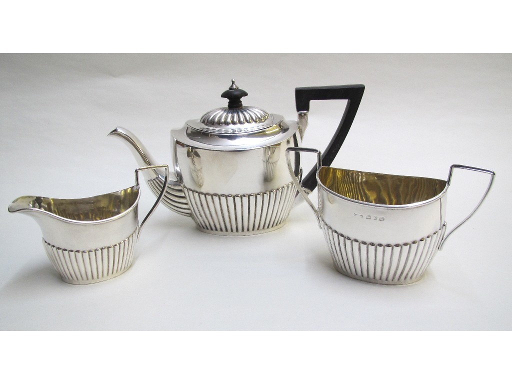 Appraisal: A Victorian silver three piece tea service with fluted lower