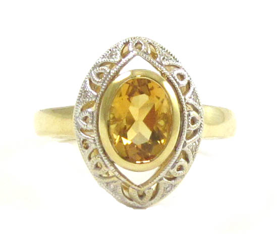 Appraisal: CITRINE AND TEN KARAT GOLD RING with an oval-cut citrine