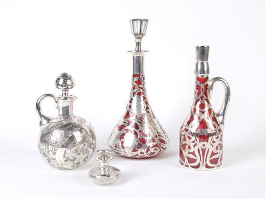 Appraisal: A Collection of Four Silver Overlay Bottles Height of tallest