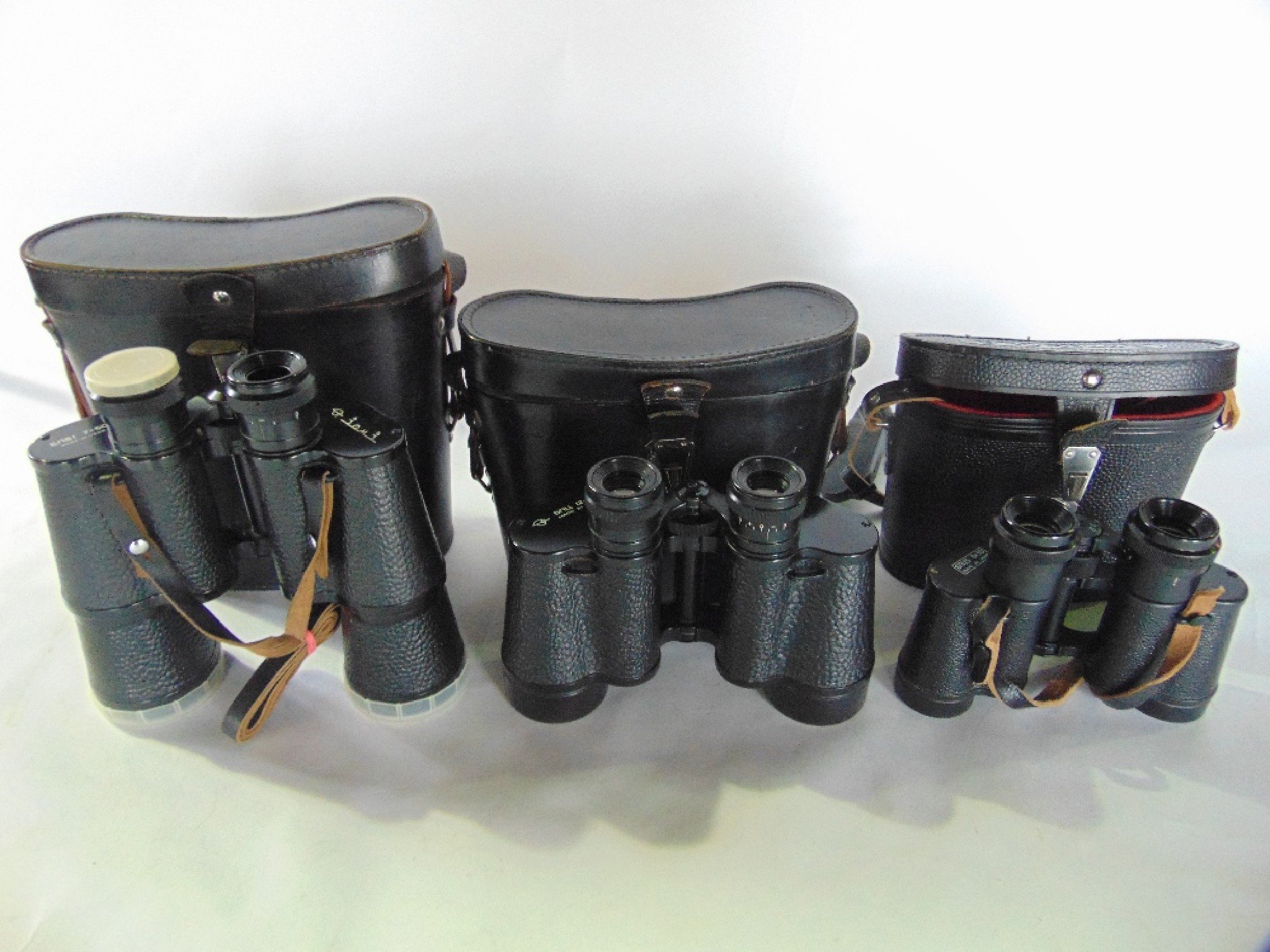 Appraisal: Three cased pairs of th century binoculars to include a