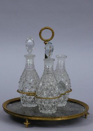 Appraisal: CHARLES X-STYLE ORMOLU-MOUNTED GLASS THREE-BOTTLE CRUET STAND The beaded and