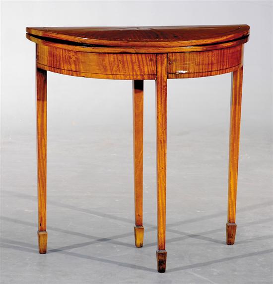 Appraisal: English satinwood games table circa demilune folding top with leather