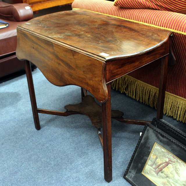 Appraisal: A GEORGIAN MAHOGANY PEMBROKE TABLE with serpentine top and standing