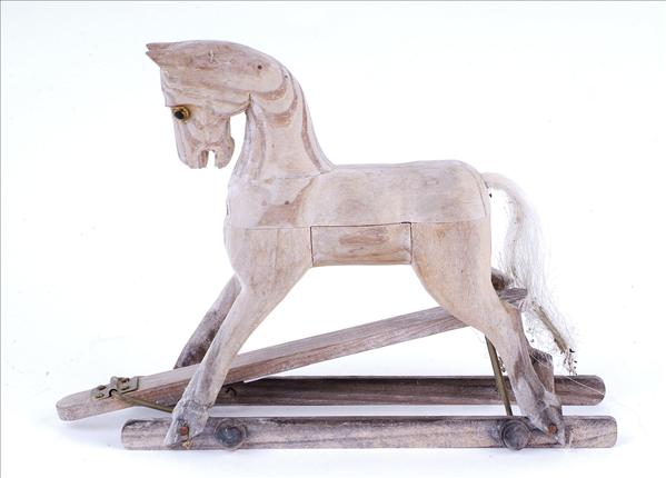 Appraisal: A miniature carved wooden rocking horse with inset glass eyes