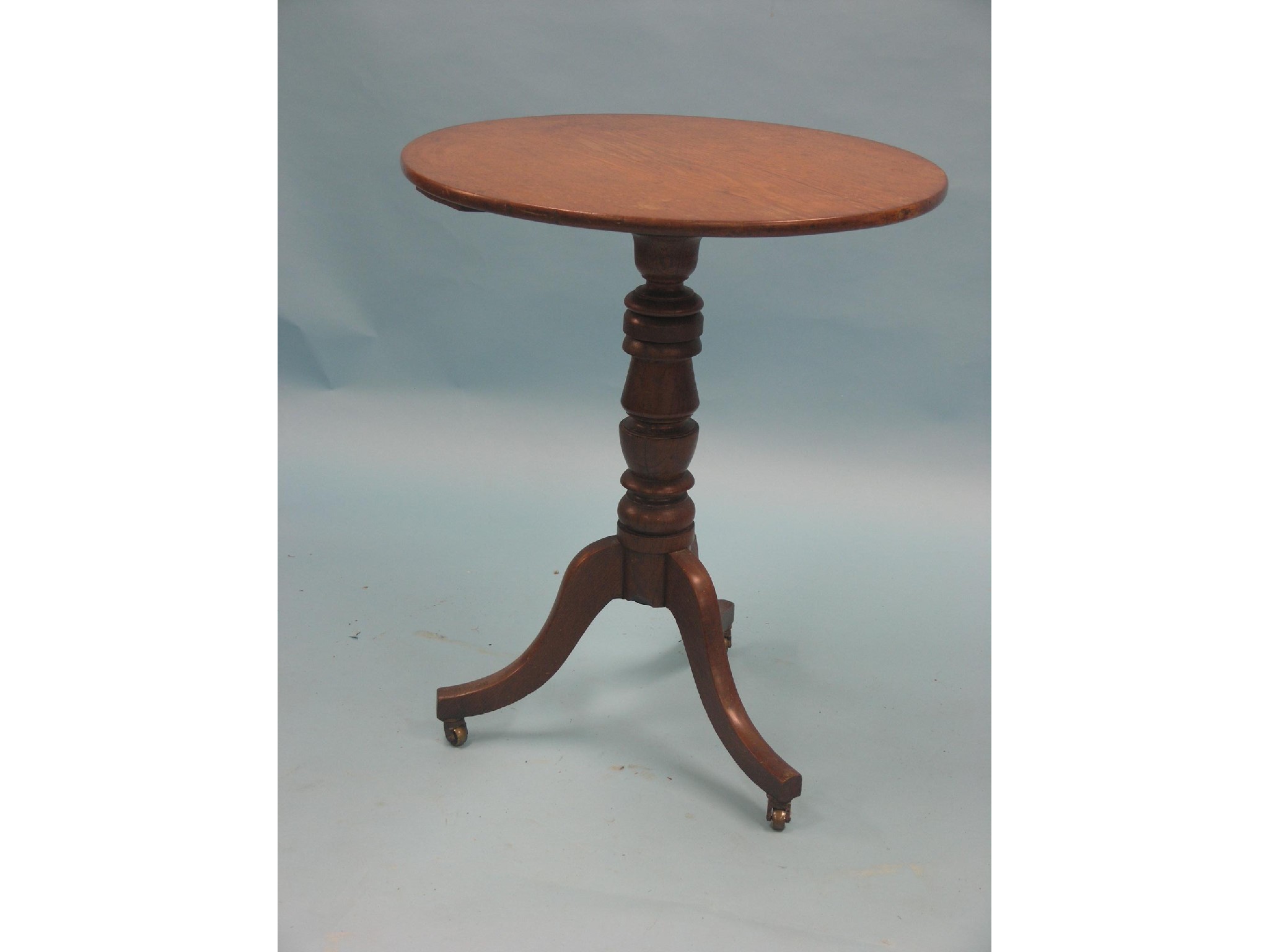 Appraisal: A Victorian oak tripod table circular top on turned stem