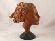 Appraisal: A carved beech model of a woman's head on black