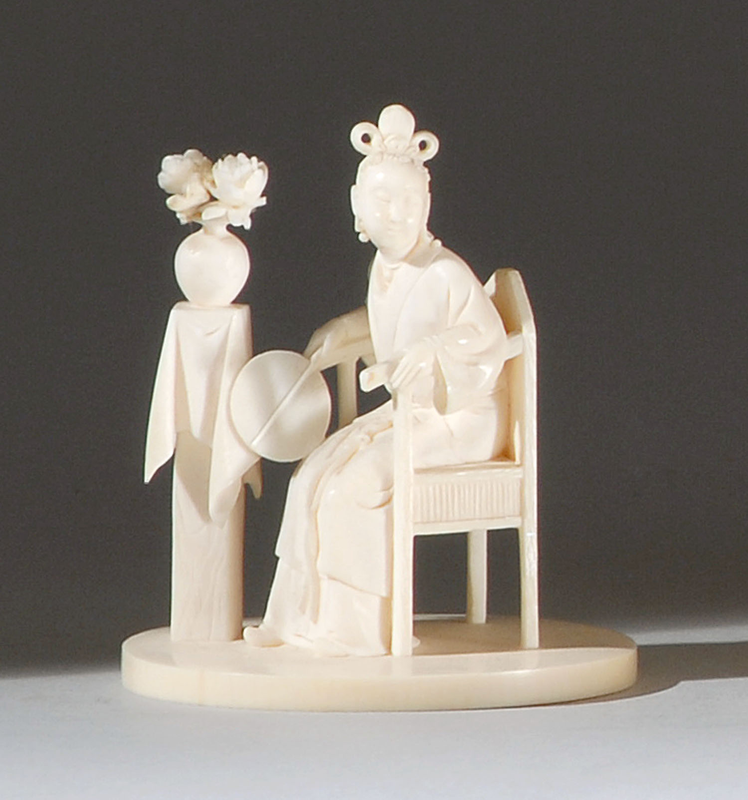 Appraisal: IVORY OKIMONO Meiji PeriodDepicting a Chinese woman seated in an