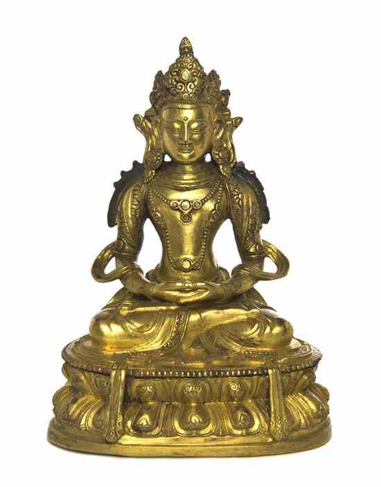 Appraisal: A Gilt Bronze Model of Guanyin depicted wearing elaborate headdress