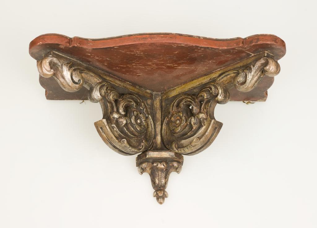 Appraisal: PAINTED AND SILVERED-WOOD WALL BRACKET the shaped rectangular shelf supported