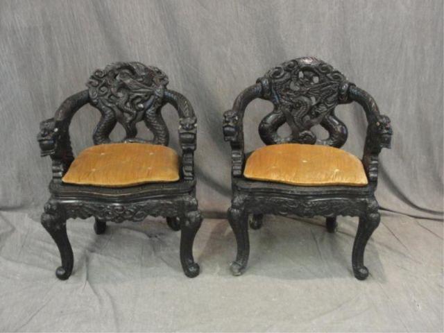 Appraisal: Pair of Highly Carved Asian Style Arm Chairs From a