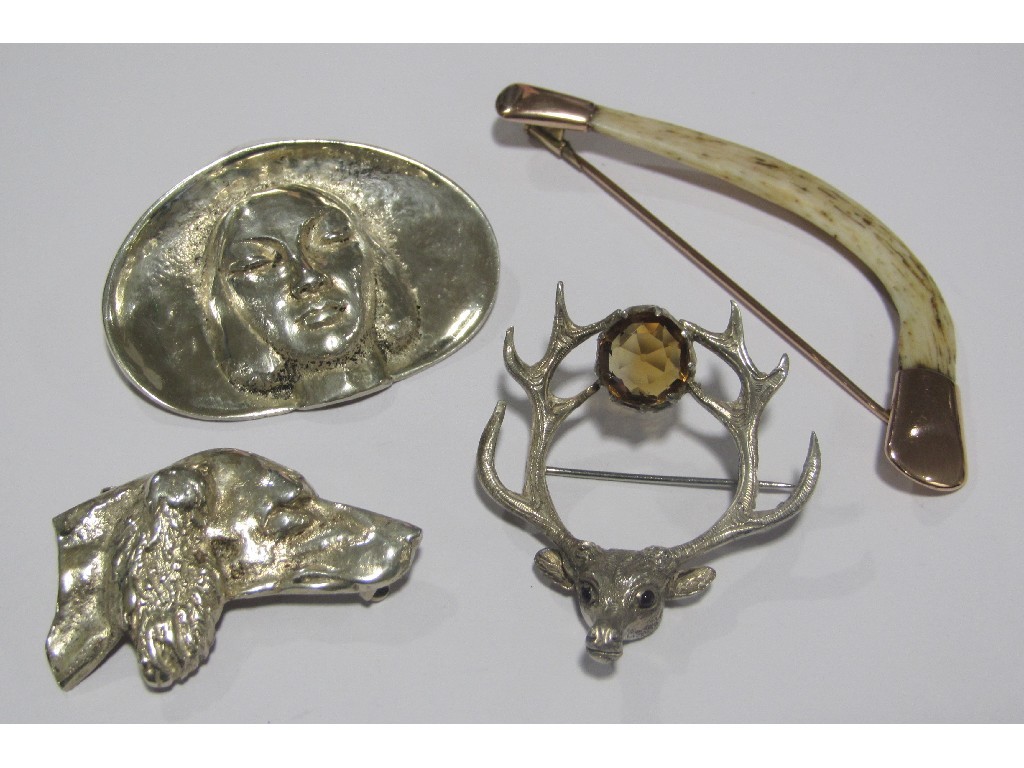 Appraisal: Lot comprising three silver brooches and a bone in yellow