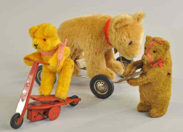 Appraisal: THREE ASSORTED TEDDY BEARS One clockwork bear holding symbols one