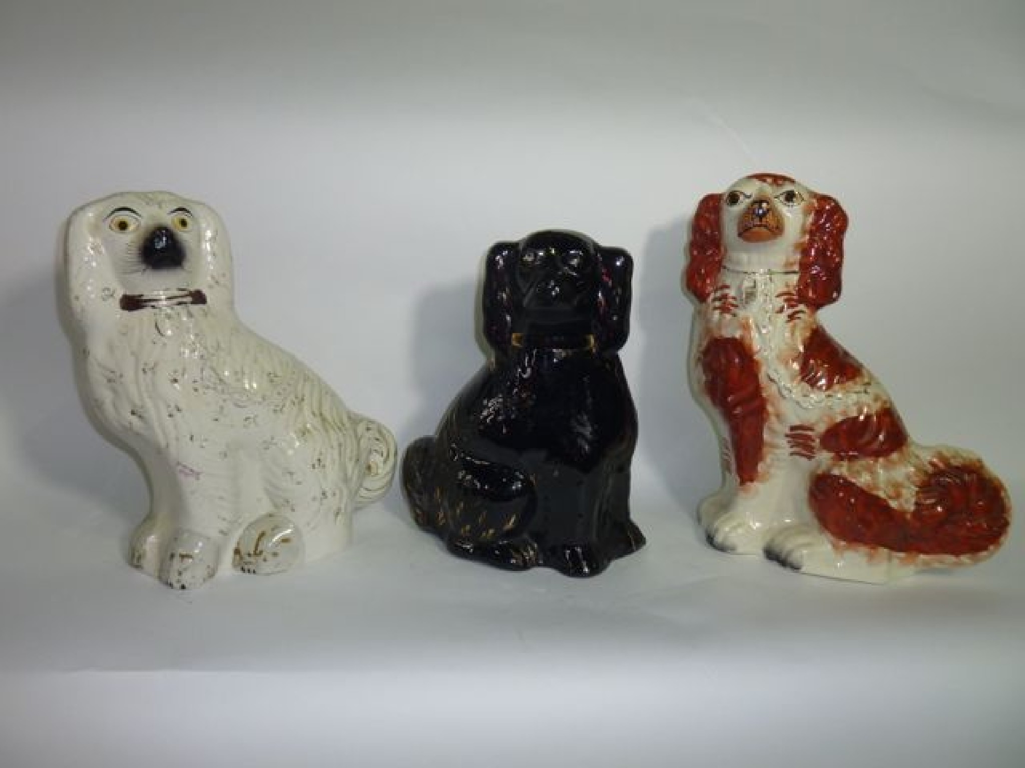 Appraisal: Two th century Staffordshire spaniels one with red and white