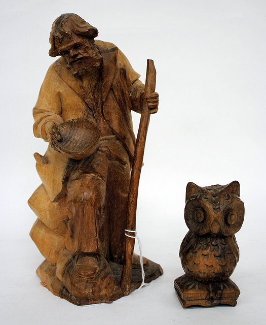 Appraisal: A CONTINENTAL SOFTWOOD CARVING in the form of a beggar