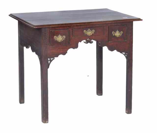 Appraisal: A GEORGE III OAK LOWBOY the top with a moulded