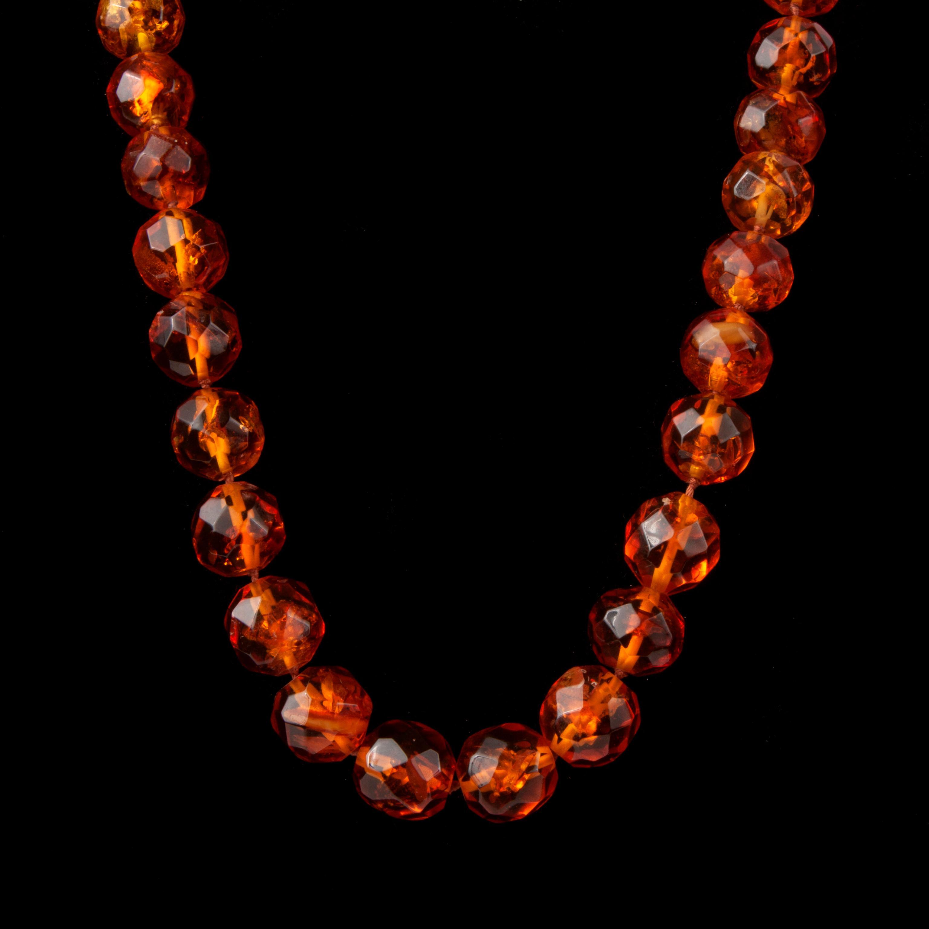 Appraisal: LARGE AMBER FACETED BEAD NECKLACE LONG Faceted amber bead necklace