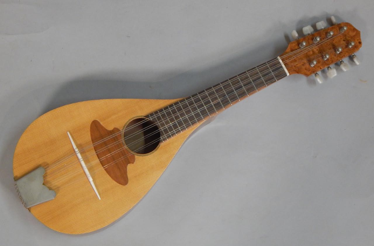 Appraisal: A walnut six string mandolin with burr walnut embellishment with