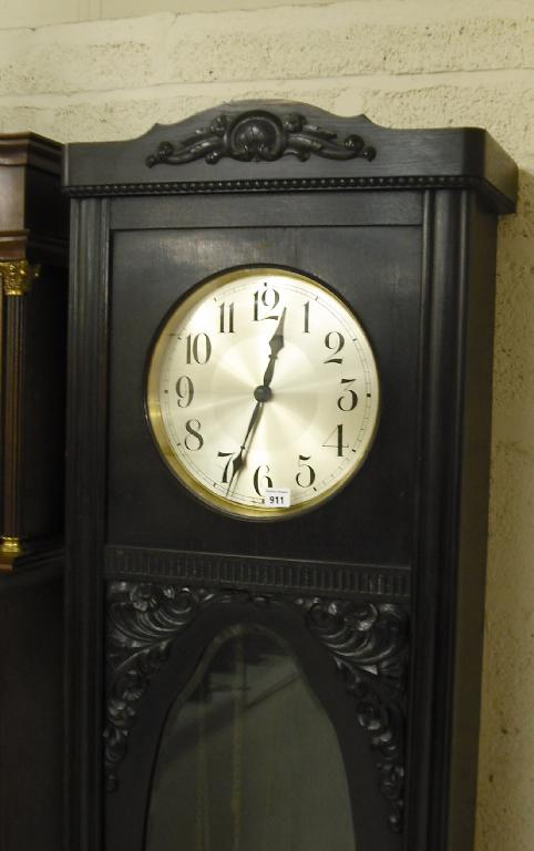 Appraisal: Ebonised oak three train longcase clock the circular silvered dial