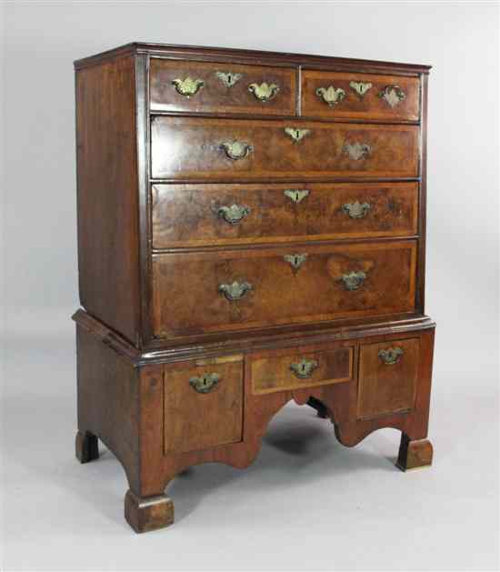 Appraisal: An early th century crossbanded walnut chest on stand with