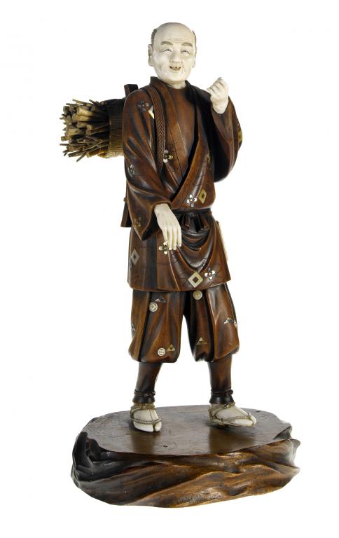 Appraisal: A WOOD AND IVORY FIGURE OF A WOOD GATHERER carrying